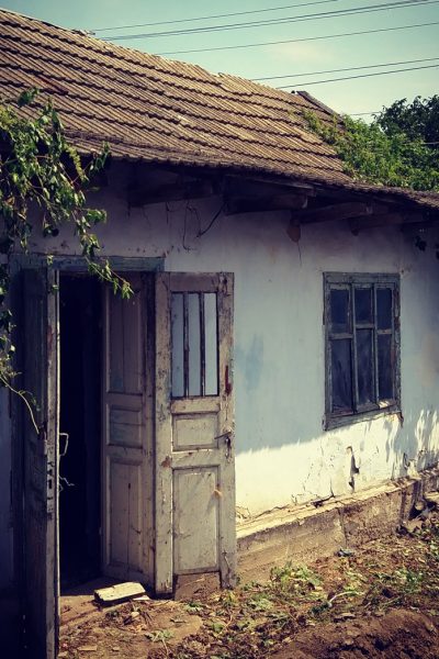 aged-rural-house-with-open-wooden-old-doors